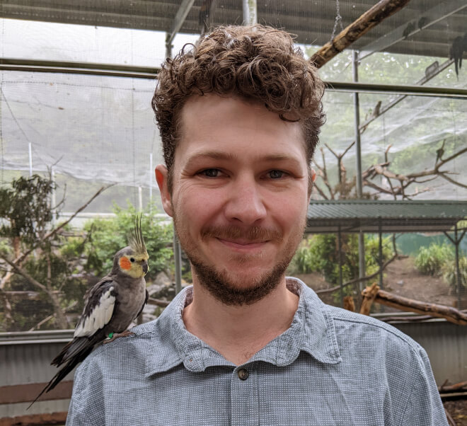Stewart with a Cockatiel on his shoulder